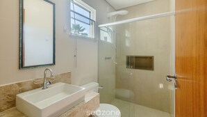 A bathroom with a sink, toilet, and glass-enclosed shower. - Beautiful Apartment 130m From the Beach Mut0054 (Porto Seguro)