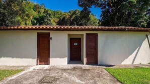 A building with a tiled roof, two wooden doors, and a small sign above the central door. - Studio 350 m From Pescadores Beach Dab0001 (Porto Seguro)