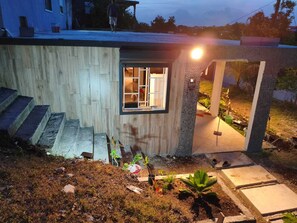 A modern house with a small porch, a window, and a staircase leading to the entrance. - Pliana Secret Garden: Cozy 2-bedroom house in serene Le Gosier with AC (Le Gosier)
