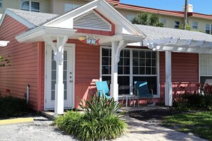 A house with a porch, a covered entryway, and a window.