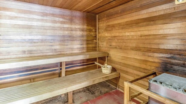 A sauna room with wooden benches, a bench with a bucket, and a metal container on a shelf. - Condo at Granlibakken Tahoe Resort - Ski-In - Ski-Out with Pool, Spa & Minutes from Lake Tahoe (Tahoe City)