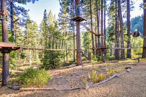 An outdoor ropes course in a forested area with wooden platforms and suspended ropes. - Condo at Granlibakken Tahoe Resort - Ski-In - Ski-Out with Pool, Spa & Minutes from Lake Tahoe (Tahoe City)