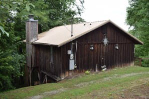 A rustic wooden building with a sloped roof, a chimney, and a small porch. - Heavenly Mountain View | Peaceful Cabin Escape (Sevierville)