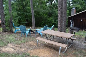 A picnic setup with a wooden table and benches, surrounded by trees. - Heavenly Mountain View | Peaceful Cabin Escape (Sevierville)