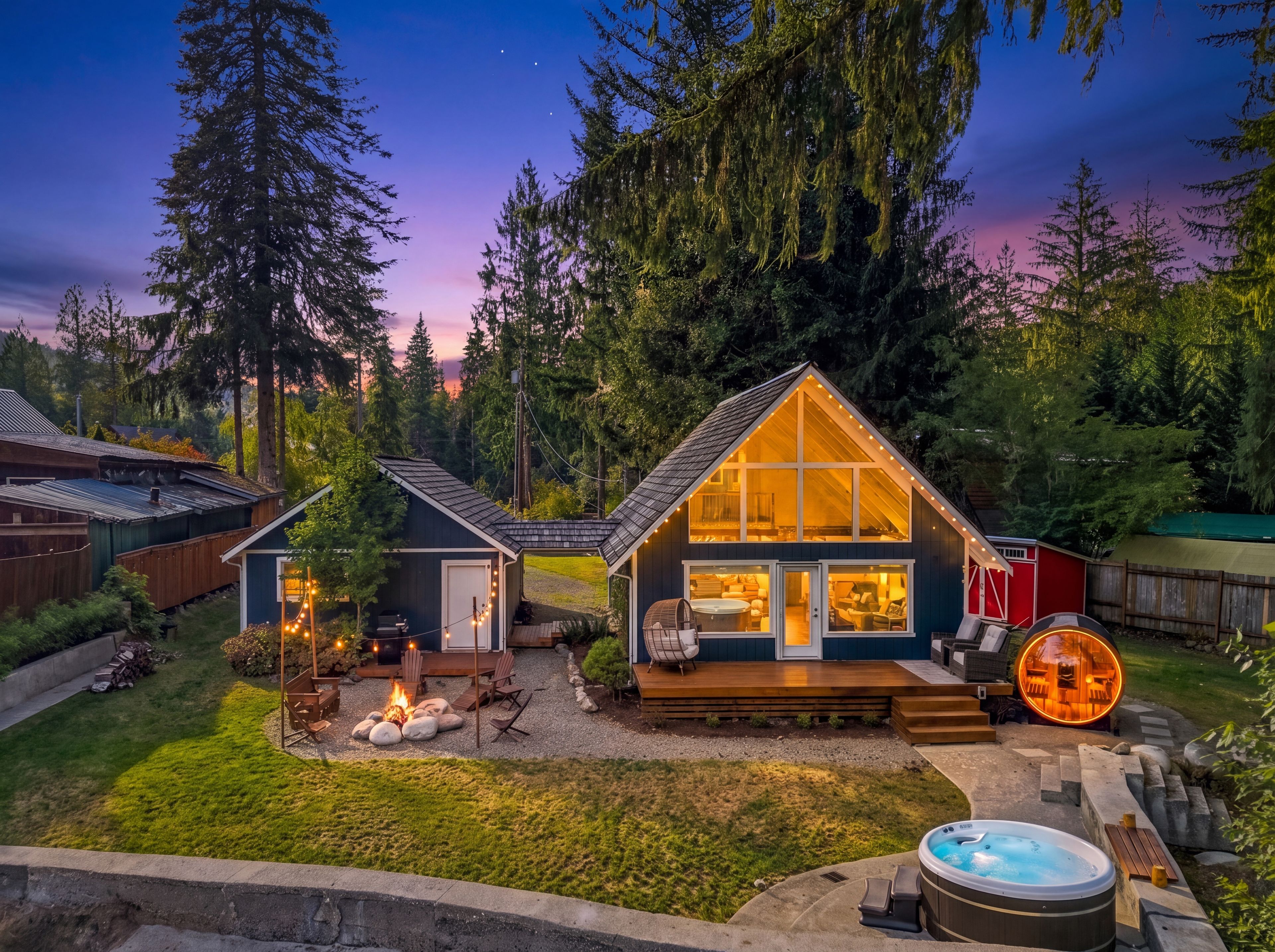 A cozy cabin with a deck, a hot tub, and a fire pit.