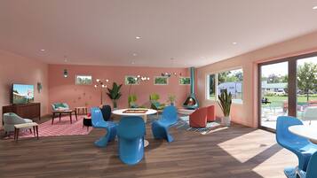 A spacious room with a large window, a fireplace, and a variety of seating arrangements.