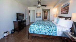 A bedroom with a bed, a TV, a dresser, and a painting on the wall. - Beachfront 2BR 11th Floor Views, Saida Royale SPI (South Padre Island)