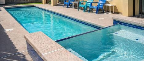 A rectangular pool with two separate sections, surrounded by a concrete deck.