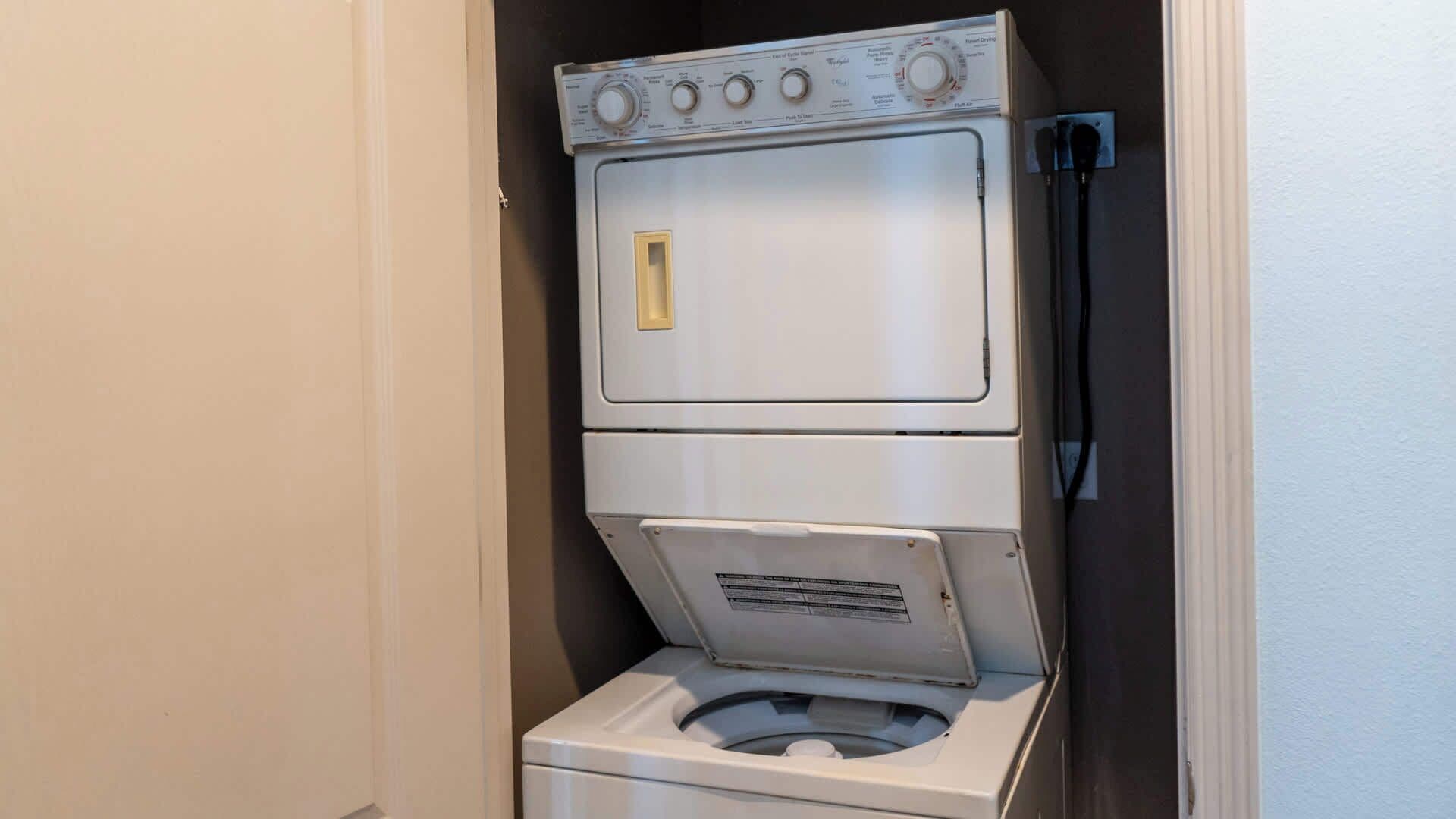 A compact, two-door laundry machine with a control panel on top and a front-loading door.
