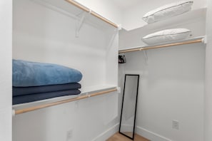 A bedroom with a bunk bed, a wardrobe, a mirror, and a shelf with folded clothes. - Luxury 7BR - Heated Pool, Hot Tub, Pet Friendly (Austin)