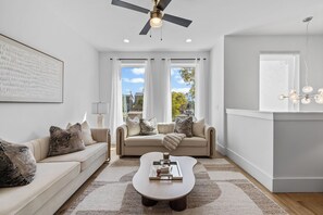 A modern living room with a sofa, coffee table, and a ceiling fan. - Ovation @ The New Cumberland Resort (Nashville)