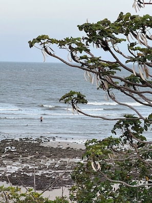 A beach with rocky terrain and a view of the ocean.