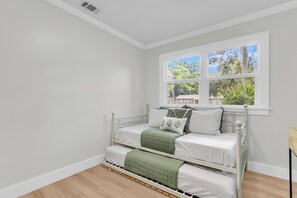 A room with a bed, a window, and a view of the outdoors. - The Lightkeeper's Cottage Beaufort, SC (Beaufort)