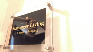 A sign with the text 'Stavanger Living' and '3. etasje Inngang' indicating a location or establishment.