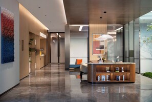 A modern lobby with a coffee station, seating area, and a reception desk. - Holiday Inn Express Shanghai North Bund Riverside By Ihg (Shanghai)