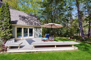 A house with a deck, outdoor seating, and a large umbrella. - Lands End House at Cape Porpoise with Hot Tub (Kennebunkport)