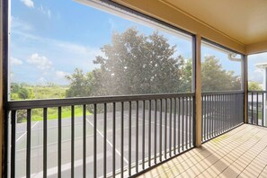 A balcony with a view of a tennis court and trees. - Peaceful Private View Disney Villa Pool Spa (Davenport)