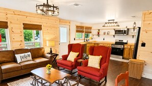 A cozy living room with a sofa, chairs, a coffee table, and a fireplace. - New Cottage, Premium Comfort, Blue Ridge Mtns, Ski, Golf (Newland)