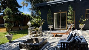 A patio with a checkered floor, outdoor seating, and potted plants. - Private retreat w hot tub, sauna & cold plunge steps from La Jolla Shores Beach (San Diego)