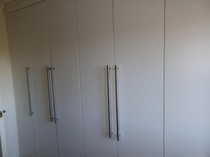 Une grande armoire avec plusieurs portes et plusieurs poignées.