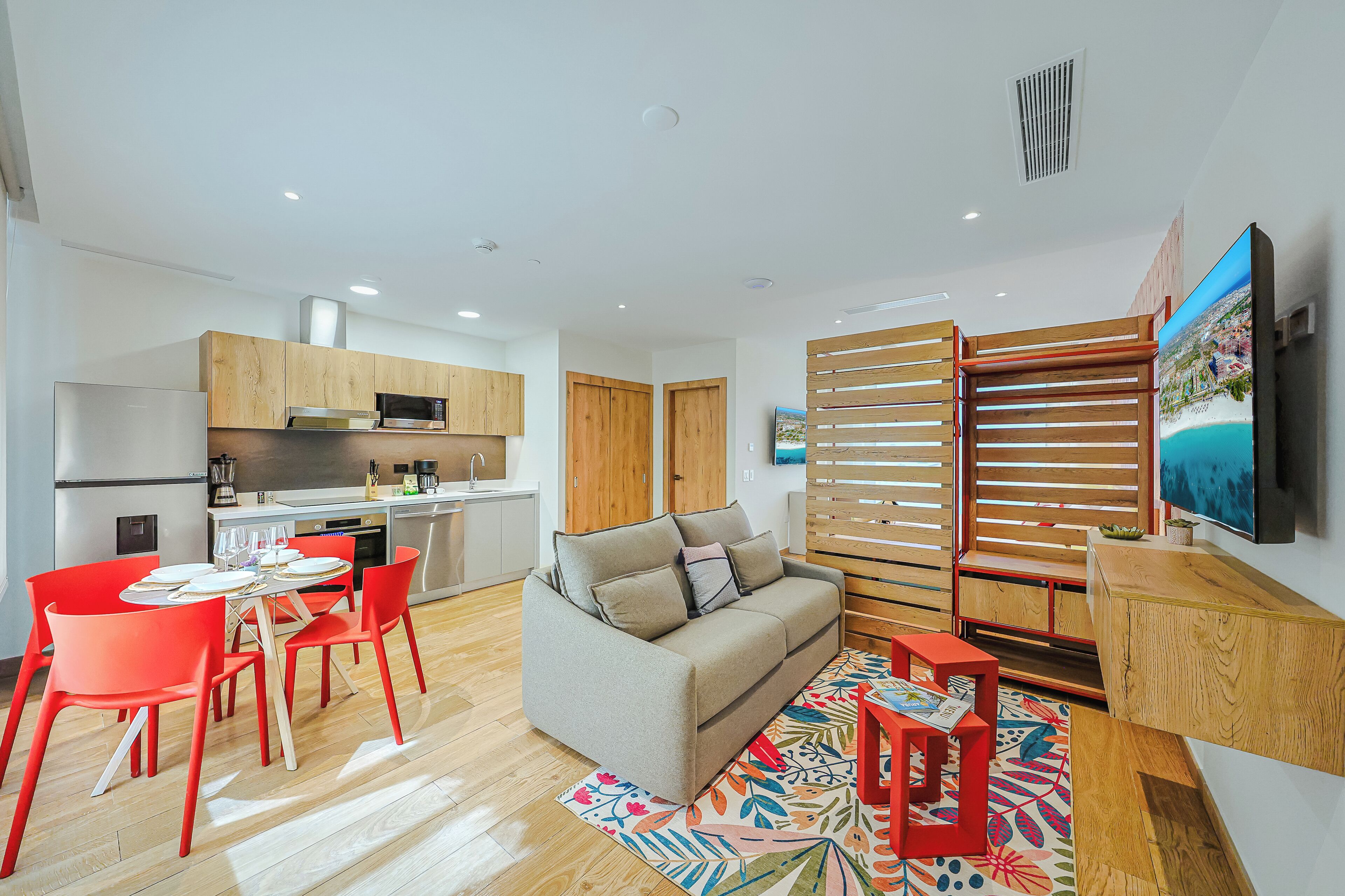 A modern apartment with a kitchen, dining area, and living room.