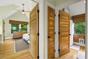 A bedroom with a large window, a bed, a dresser, and a ceiling fan. - NEW! Quaint 2BR apt in Harpswell with private beach area and beautiful gardens (Harpswell)