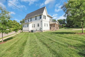 A two-story house with a covered porch and a lawn. - East Nash Luxe Minutes to Nissan Stadium & Five Points (Nashville)