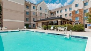 A hotel with a swimming pool, outdoor seating, and a covered patio area. - Accessible 1BR King Suite | Free Breakfast + Pool (Allentown)