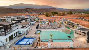 A resort with multiple swimming pools, outdoor seating areas, and a mountainous backdrop. - Zion Vacation - Sleeps 12 - Hot Tub, Golf, Waterpark (Hurricane)