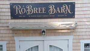 A two-door white front entrance with a sign above stating 'Robree Barn' and 'The Beautiful Island of Martha's Vineyard, Oak Bluffs, MA'. - Charming 1-bedroom bungalow with AC in Oak Bluffs (Oak Bluffs)