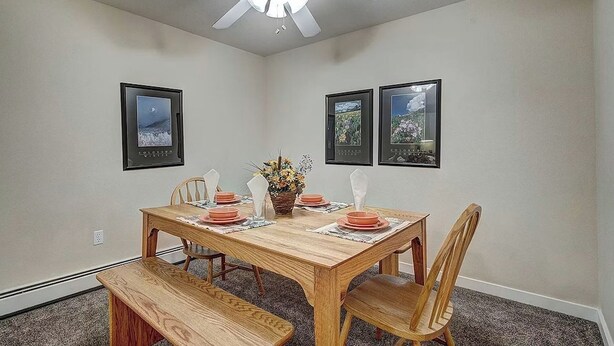 A dining room with a wooden table set for four, a ceiling fan, and framed pictures on the walls. - BARGAIN! -- Up to 8 @ Swan Mtn. Resort Keystone/Dillon 8/8-15 - 40% off 6+ nites (Keystone)