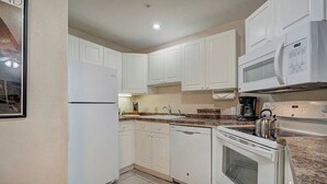 A compact kitchen with white cabinets, a built-in microwave, a kettle, and a dishwasher. - BARGAIN! -- Up to 8 @ Swan Mtn. Resort Keystone/Dillon 8/8-15 - 40% off 6+ nites (Keystone)