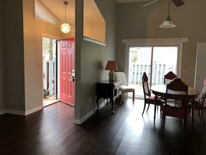 A room with a dining table, chairs, a lamp, and a red door. - gorgeous house central to shopping, military  base and hospitals. Best schools (Fayetteville)