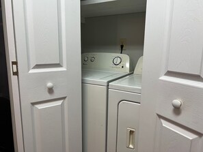 A laundry room with a washing machine and dryer. - gorgeous house central to shopping, military  base and hospitals. Best schools (Fayetteville)
