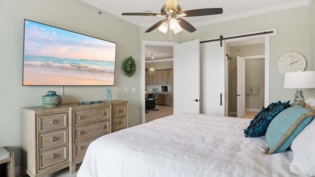A bedroom with a bed, a ceiling fan, a TV, a dresser, and a view of the kitchen. - Penthouse Main Channel Views, Resort Pools & Boat Slip at Topsider's 19mm (Osage Beach)