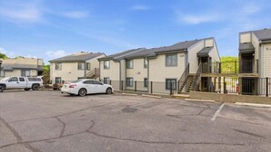 A row of multi-story apartment buildings with a parking lot in front. - Family-friendly Condo at the 1MM Boat Slip, Lake Views + Pool Access Near Bagnell Dam (Lake Ozark)