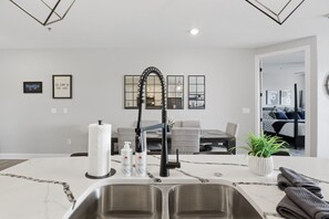 A modern kitchen with a double sink, a roll of paper towels, and dish soap. - Main Channel Views, Resort Pools & Boat Slip at Topsider's 19mm (Osage Beach)