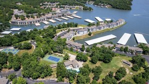 An aerial view of a waterfront property with multiple buildings, docks, and green spaces.