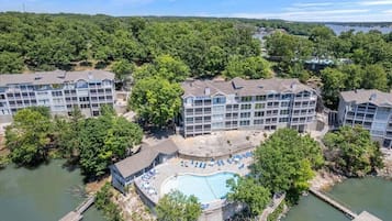 A hotel with multiple buildings, a swimming pool, and a dock.