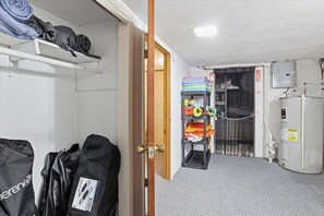 A room with a bunk bed, a heater, and a shelf with folded clothes. - Lakefront Home w/ Private Dock, Great Views, Huge Deck & Water Toys (Gravois Mills)