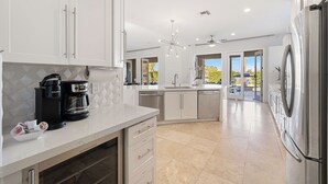 A modern kitchen with a built-in coffee maker, a dishwasher, and a refrigerator. - Casa Sonora Grande - A Palm Springs 6 bedroom gem! (Palm Springs)