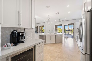 A modern kitchen with a built-in coffee maker, a dishwasher, and a refrigerator. - Casa Sonora Grande - A Palm Springs 6 bedroom gem! (Palm Springs)
