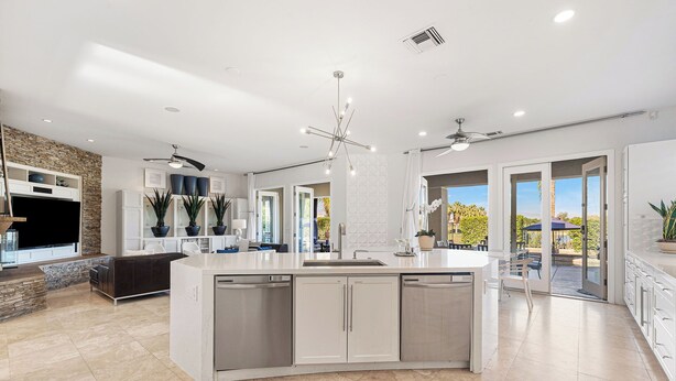 A spacious kitchen with a central island, built-in appliances, and a view to an outdoor patio. - Casa Sonora Grande - A Palm Springs 6 bedroom gem! (Palm Springs)