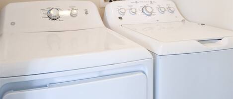 Two front-loading washing machines in a laundry room.