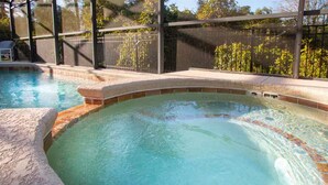 A swimming pool with a stone edge and a clear blue water surface. - 4Bed/3Bath Perfect Location, Perfect Home (Kissimmee)