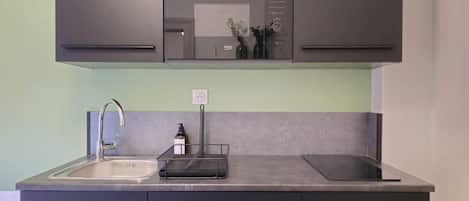 A modern kitchen with a built-in oven, a sink, and a countertop.