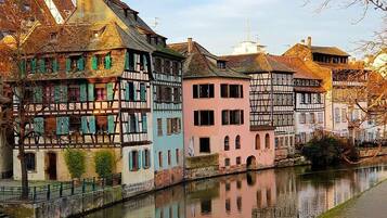 A canal with buildings reflecting on the water.