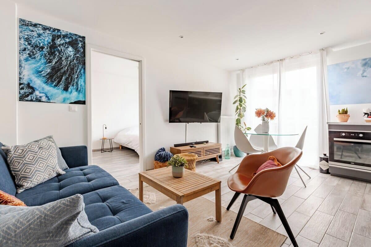A modern living room with a sofa, coffee table, and a TV.