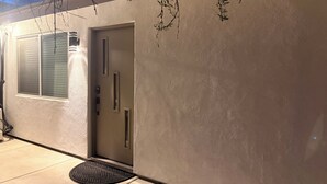 A building exterior with a door, a window, and a doormat. - Beautiful Guesthouse in Kierland. Studio A (Scottsdale)