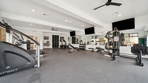 A gym with treadmills, stationary bikes, and weight machines. - Modern 2-Bed/2-Bath Apartment in Owasso, OK (Owasso)